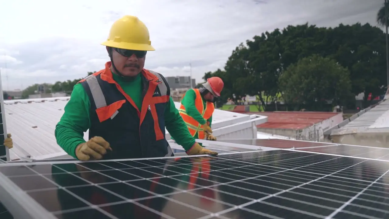 Technicians installing solar panels on a rooftop